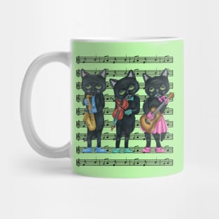 Three Black Cats Playing Musical Instruments on Sheet Music Mug